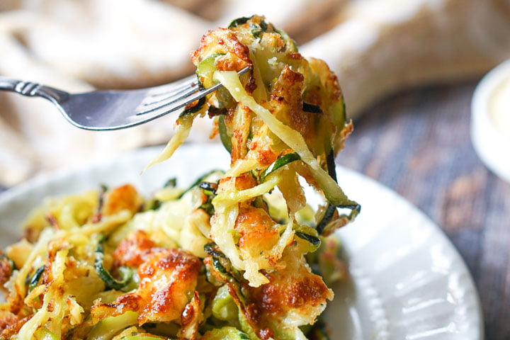 a fork full of low carb zucchini noodles with cheese