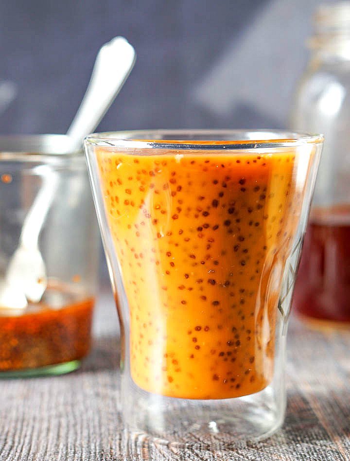 the finished low carb thai tea with chia seeds and jars in the background with spoons