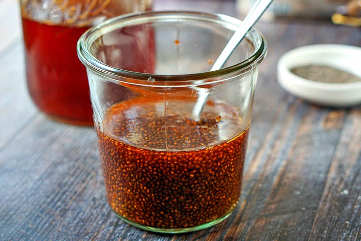 glass jar with a spoon and the swelled chia seeds