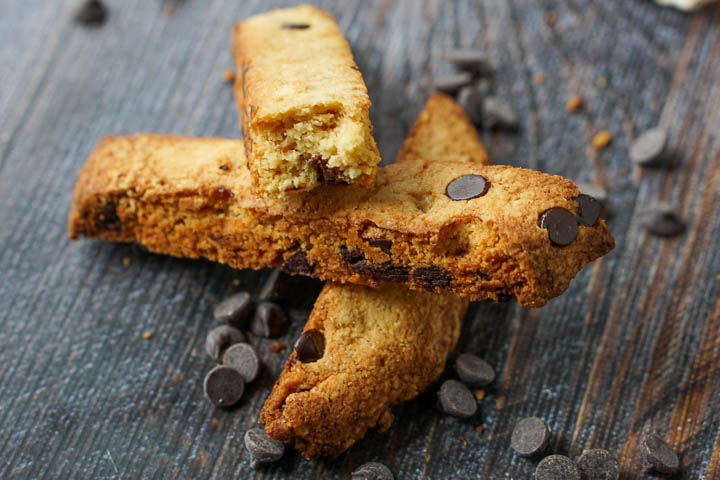 3 pieces of chocolate chip keto biscotti with scattered sugar free chocolate chips