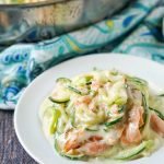 pan and white plate with keto salmon alfredo with zucchini noodles and text