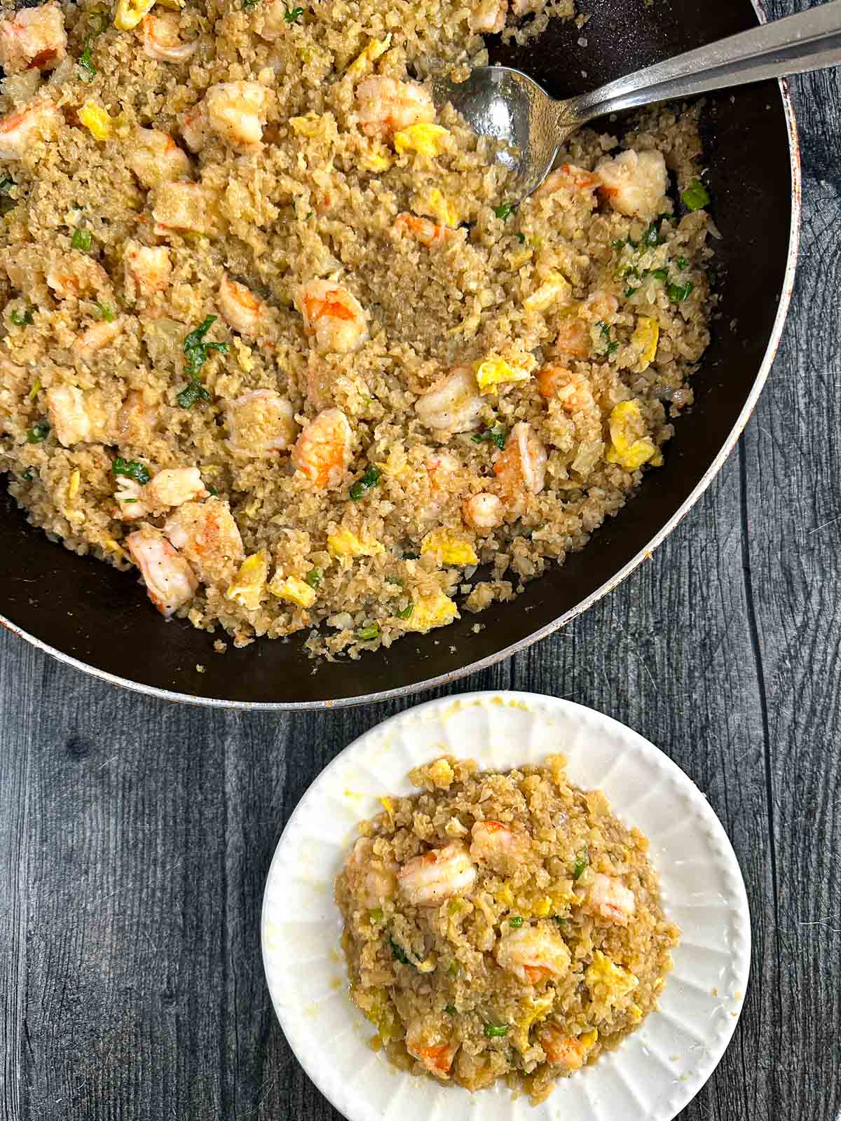 Aerial view of a pan and plate of the keto shrimp fried rice.