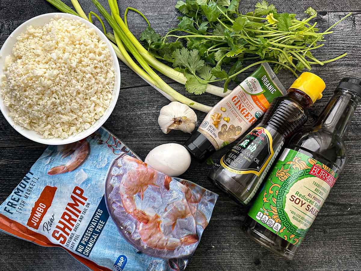 Recipe ingredients - cauliflower, green onions, cilantro, shrimp, egg, garlic, ginger, sesame oil, and soy sauce.