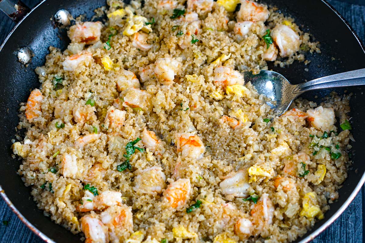 Closeup of a skillet with the finished keto fried rice with shrimp and cauliflower rice.