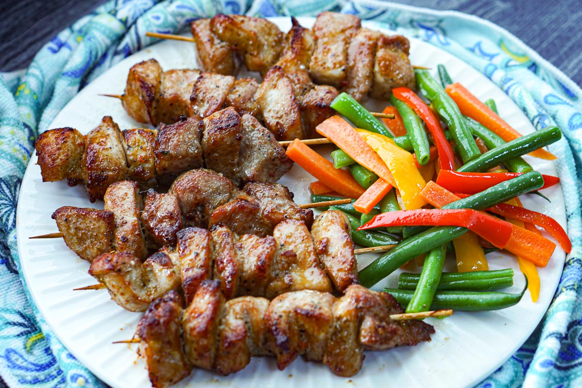 closeup of a plate of air fryer pork kebabs and veggies