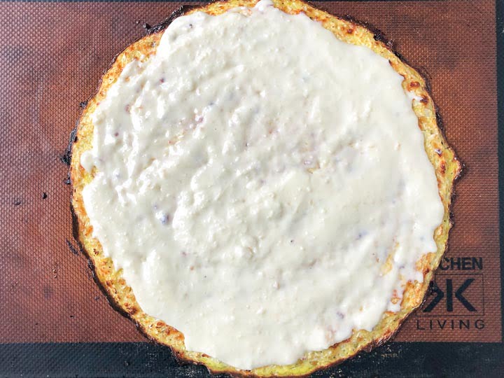 cooked cauliflower crust with keto Alfred sauce on top