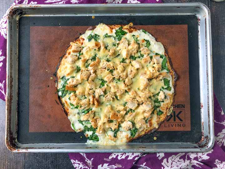 keto chicken alfredo pizza on a cookie sheet just out of the oven