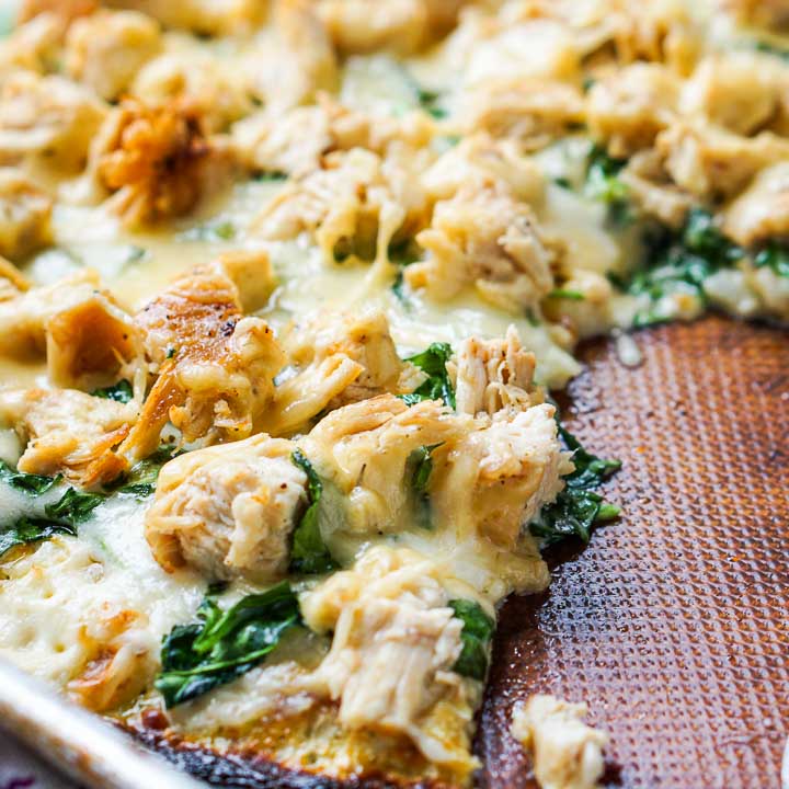 close up of the cauliflower crust pizza with chicken and spinach