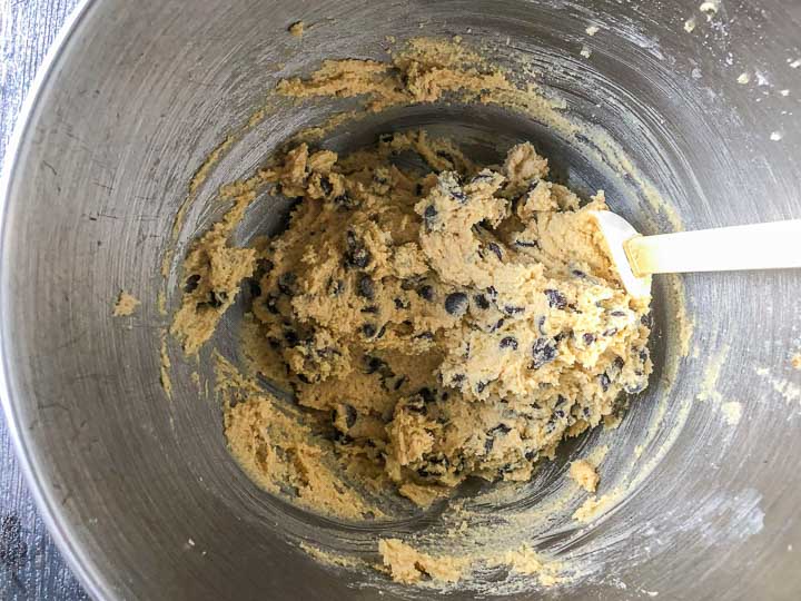 low carb chocolate chip cookie batter in silver bowl with white spatula