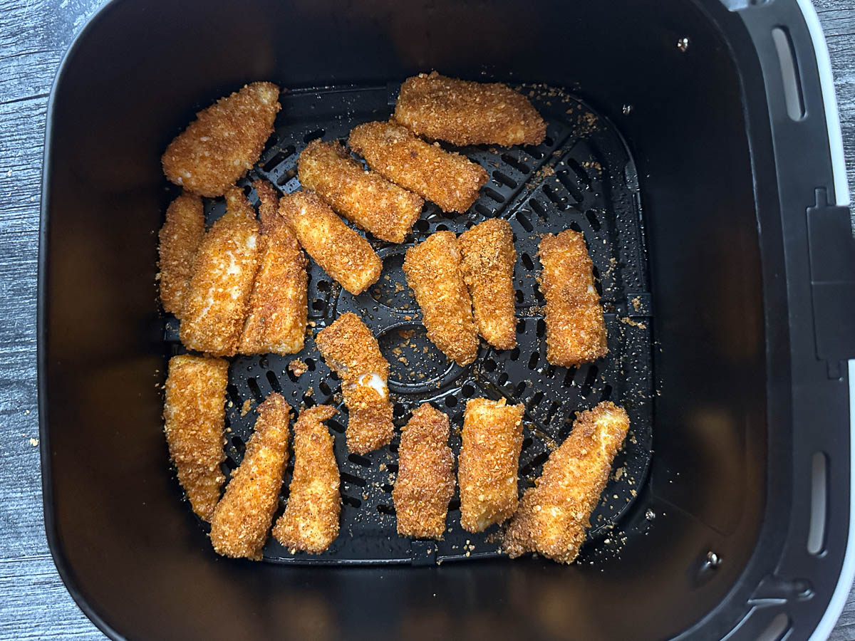 Air fryer basket with the fished dish.