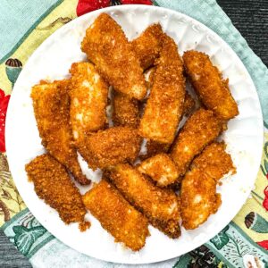 White plate with air fryer keto fish sticks.