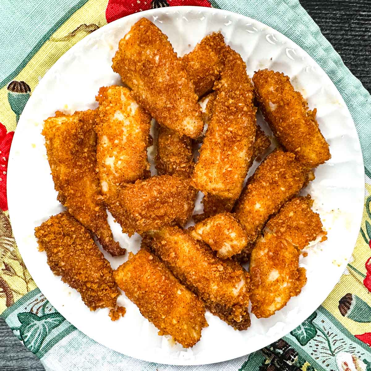 White plate with air fryer keto fish sticks.