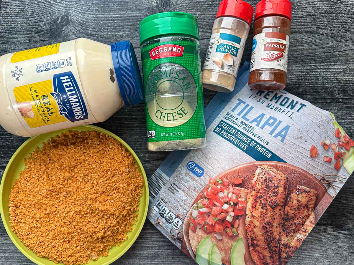 Recipe ingredients - mayonnaise, tilapia, ground pork rinds, parmesan cheese, garlic powder, paprika.