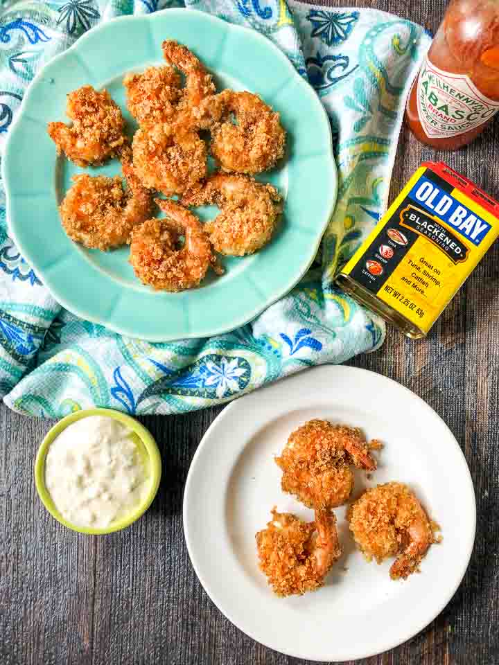 white and blue plate with air fryer fried shrimp and old bay seasoning, tabasco and tartar sauce