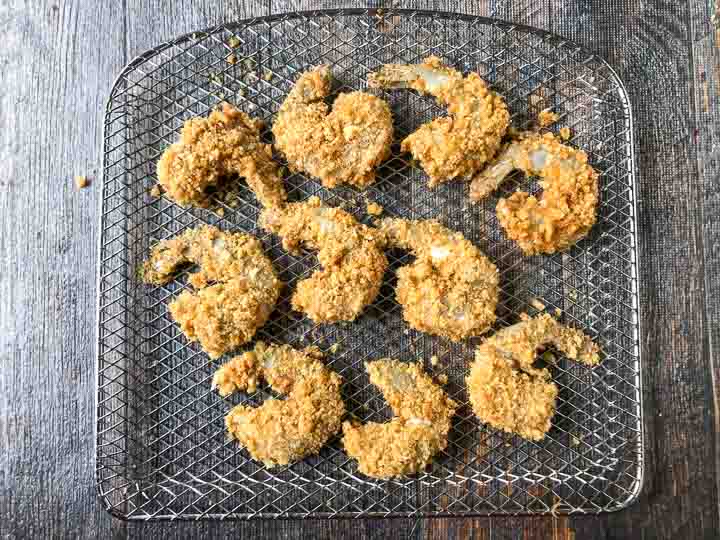 air fryer tray with raw low carb breaded shrimp ready to bake