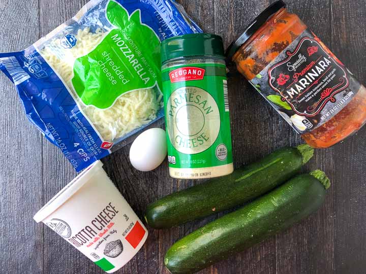 Aldi ingredients to make mini zucchini lasagna cups: shredded mozzarella, parmesan cheese, marinara sauce, ricotta cheese, egg and zucchini