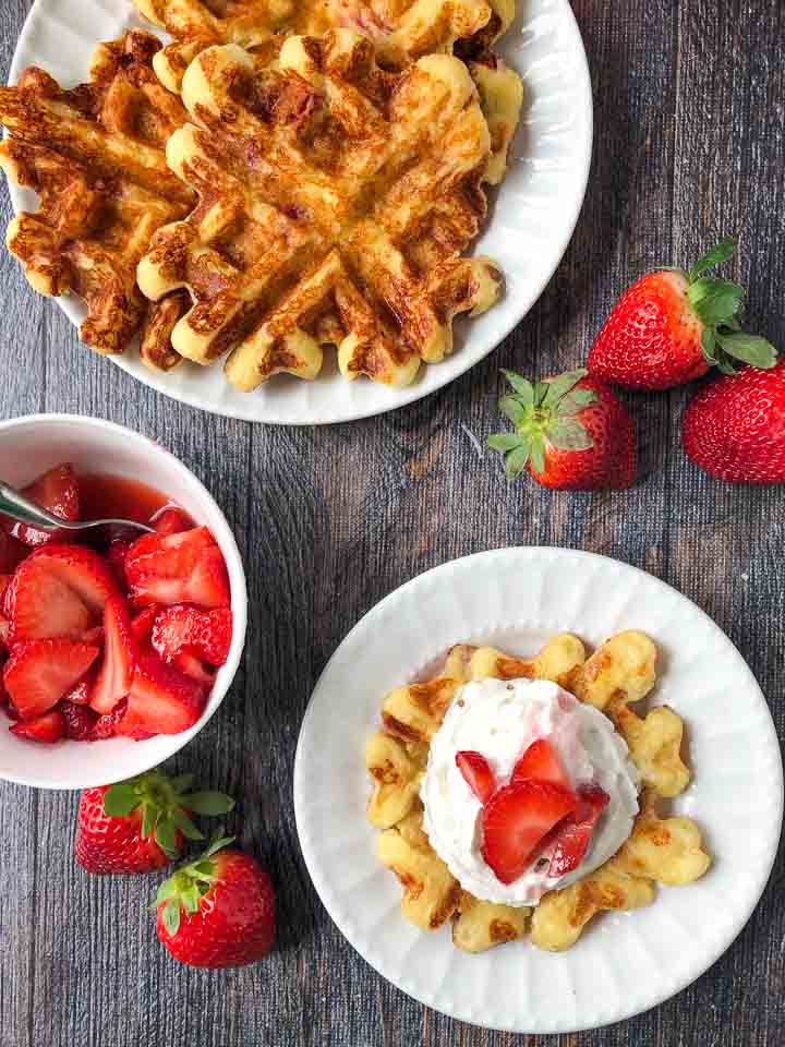 aerial view of keto waffles with fresh strawberries and whipped cream 