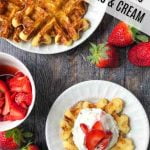 keto chaffle on white plate with strawberries and cream and text