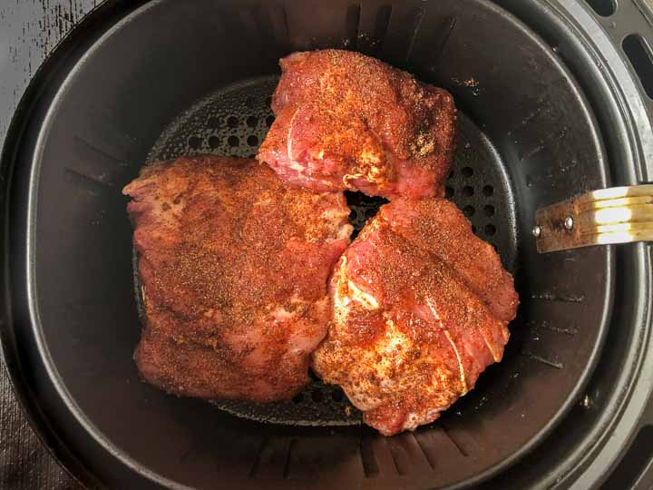 air fryer basket with the rubbed keto baby back ribs ready to cook