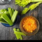 glass dish with microwave keto buffalo chicken dip with celery and text