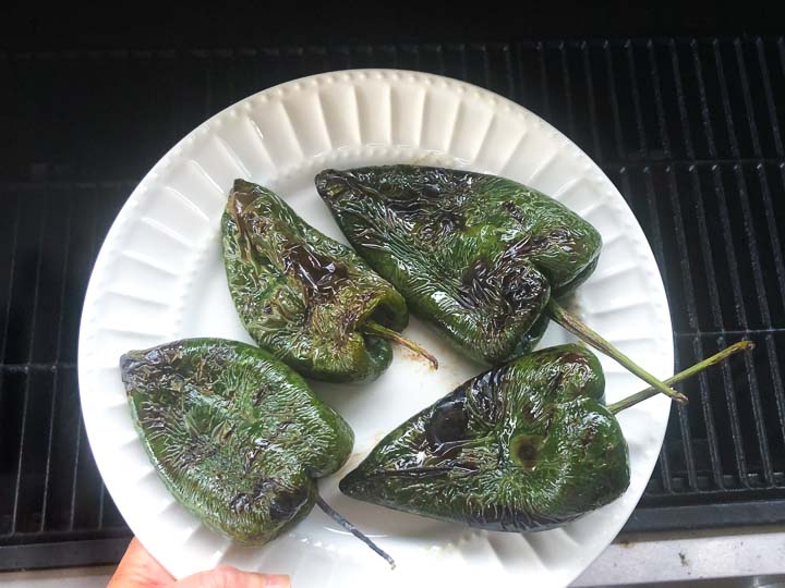 white plate with 4 grilled poblanos