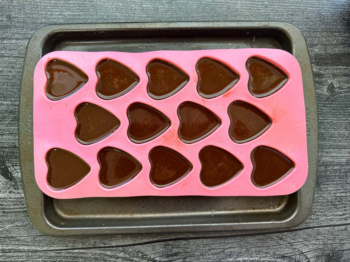 pink hearty mold with liquid chocolate mixture