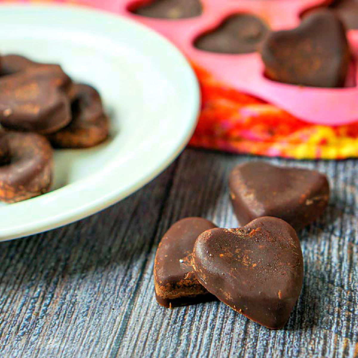 white plate and few scatter chocolate peanut butter heart chocolates
