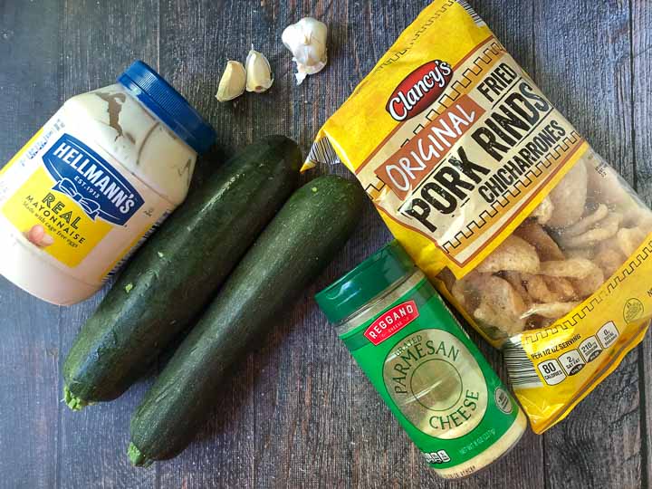 ingredients to make keto fried zucchini: zucchini, mayonnaise, garlic, and pork rinds