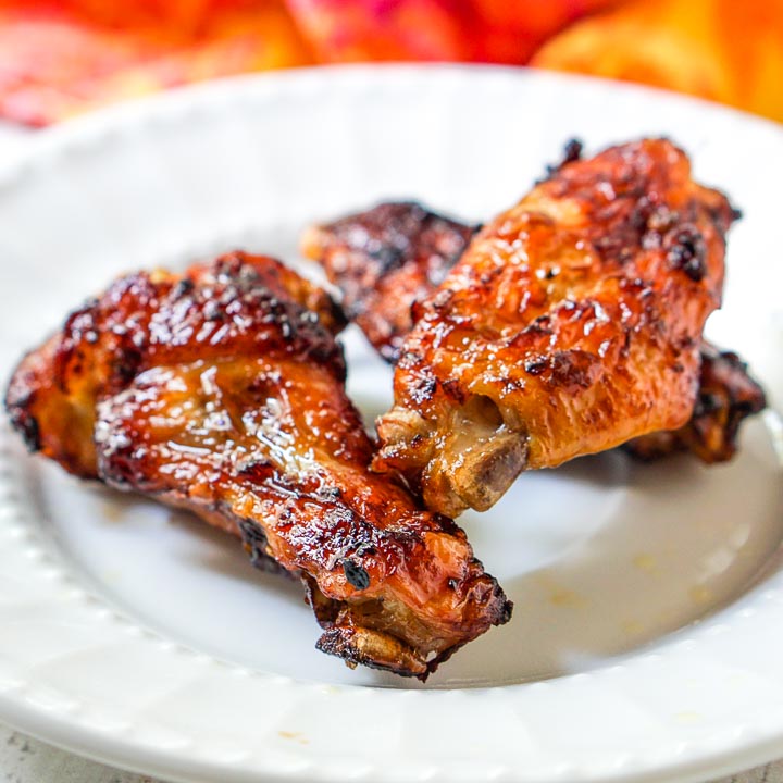 3 keto spicy Asian wings made in the air fryer on a white plate
