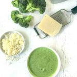 white bowl with broccoli cheese blender soup and text overlay