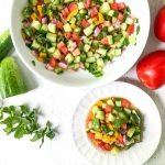 white bowl and plate with low carb chopped cucumber garden salad with text