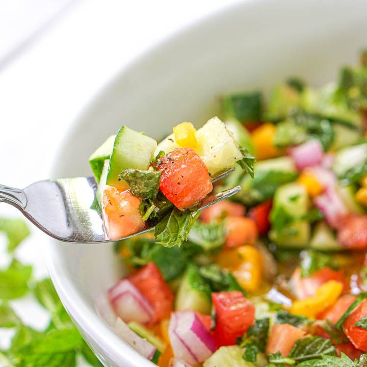 forkful of low carb chopped cucumber garden salad