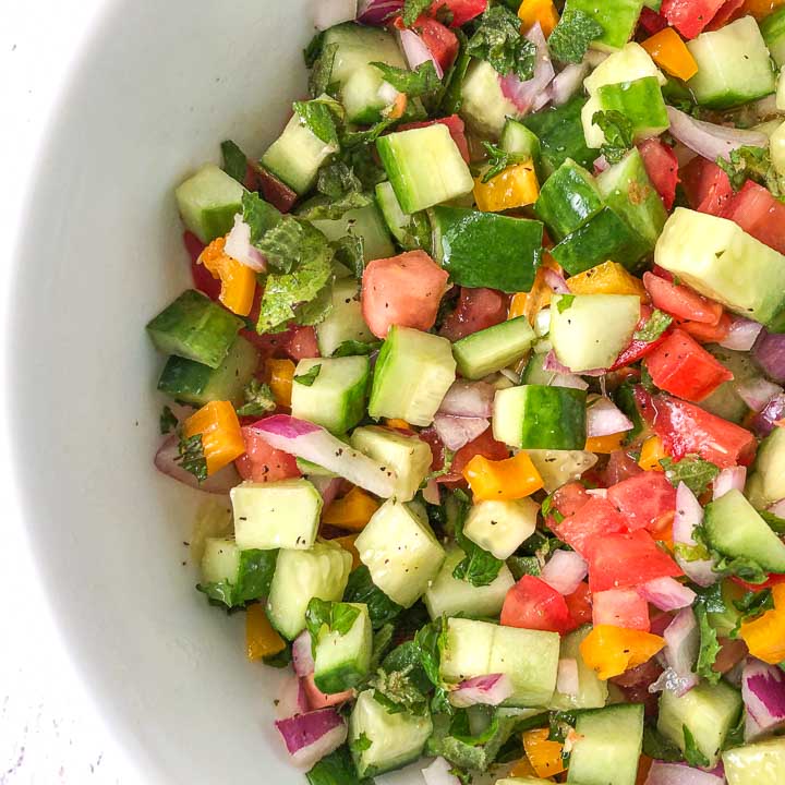 closeup of white bowl with low carb chopped cucumber garden salad