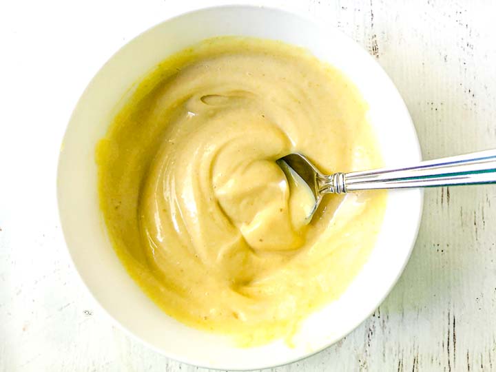 white bowl with low carb sweet mustard dip and a spoon