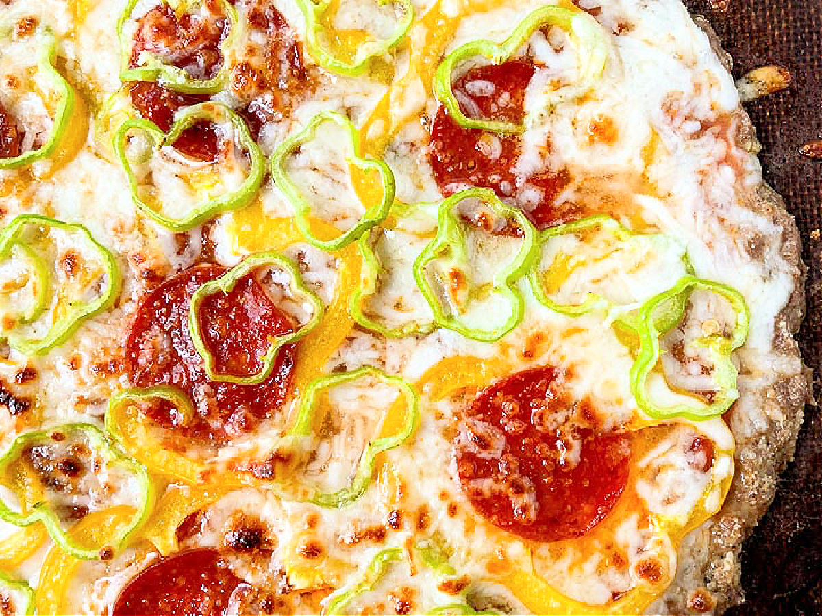closeup of meatza with pepperoni and peppers
