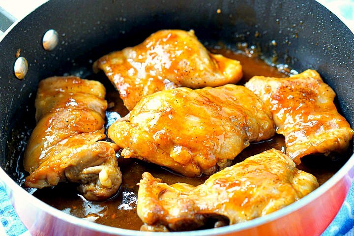 orange pan with 5 keto chicken thighs with sugar free brown sugar glaze