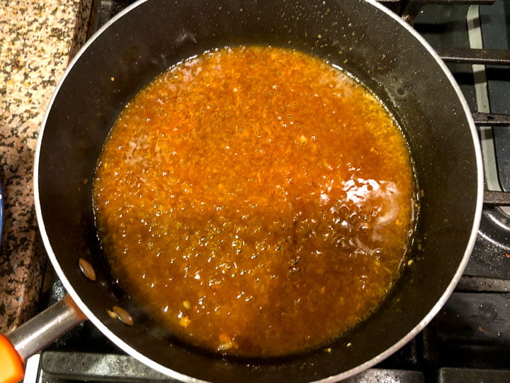 pan with simmering sugar free chicken glaze sauce