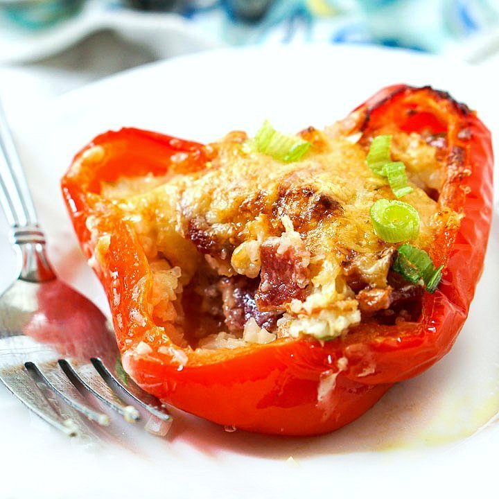 red bell pepper stuffed with cheesy bacon cauliflower rice and fork