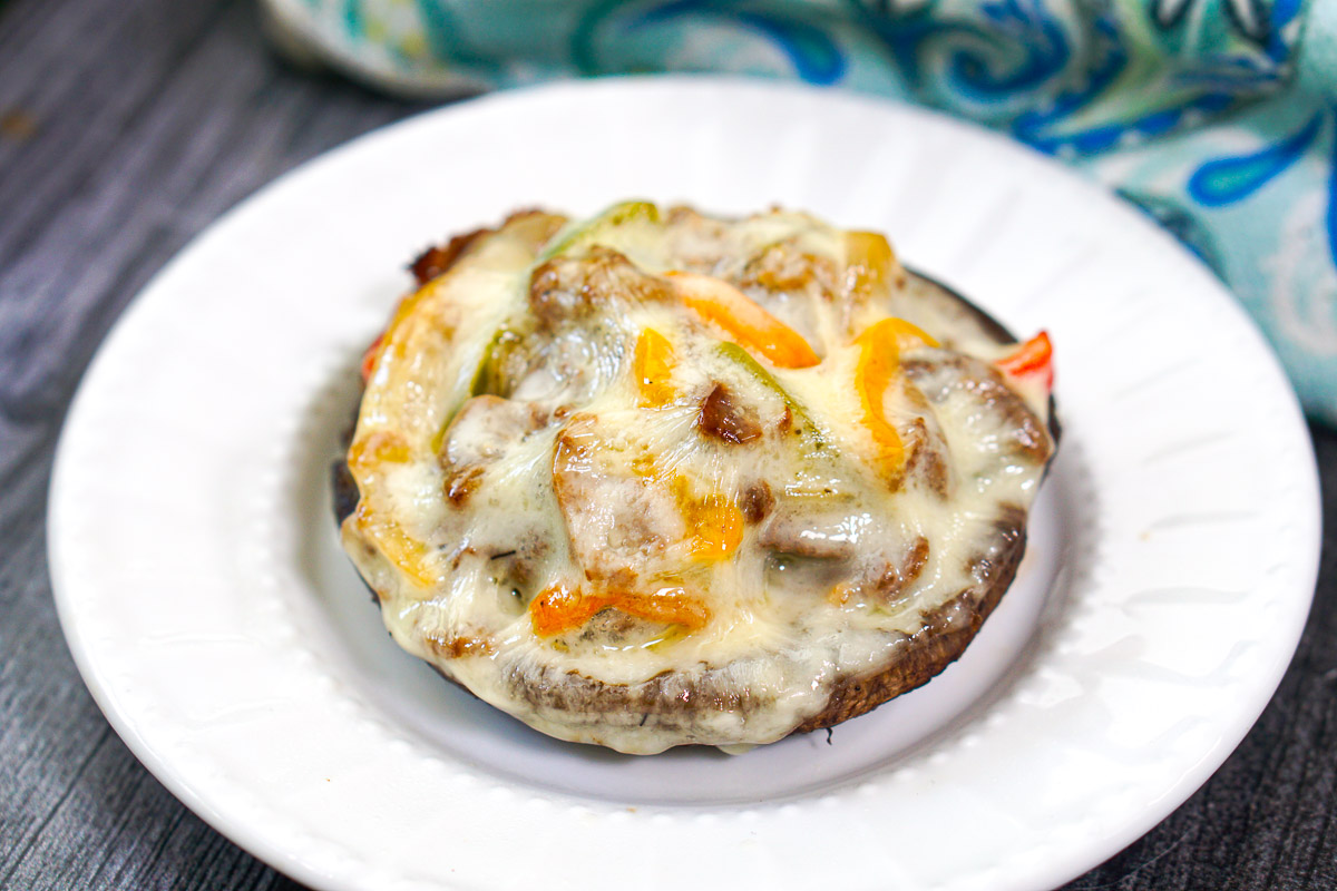 closeup fo a steak filled portobello mushroom with cheese