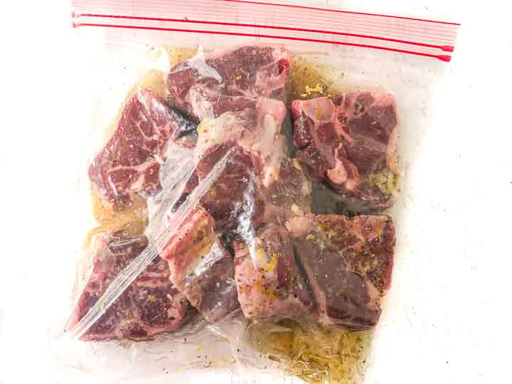 baggie with marinaded raw lamb chops