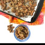 blue dish and cookie sheet with keto granola with a bright towel and text overlay