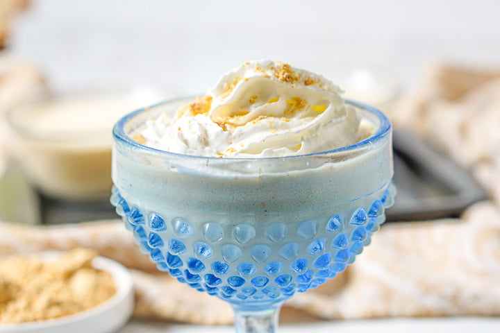closeup of glass bright blue dessert dish with banana pudding