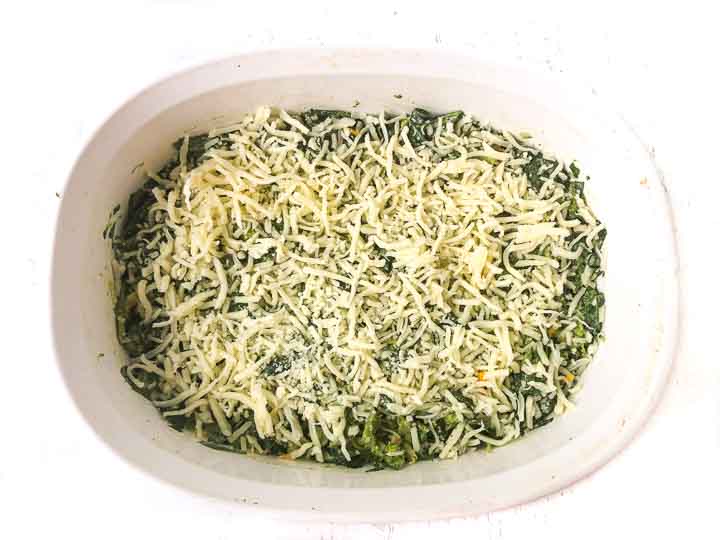 white baking dish with broccoli casserole ready to bake