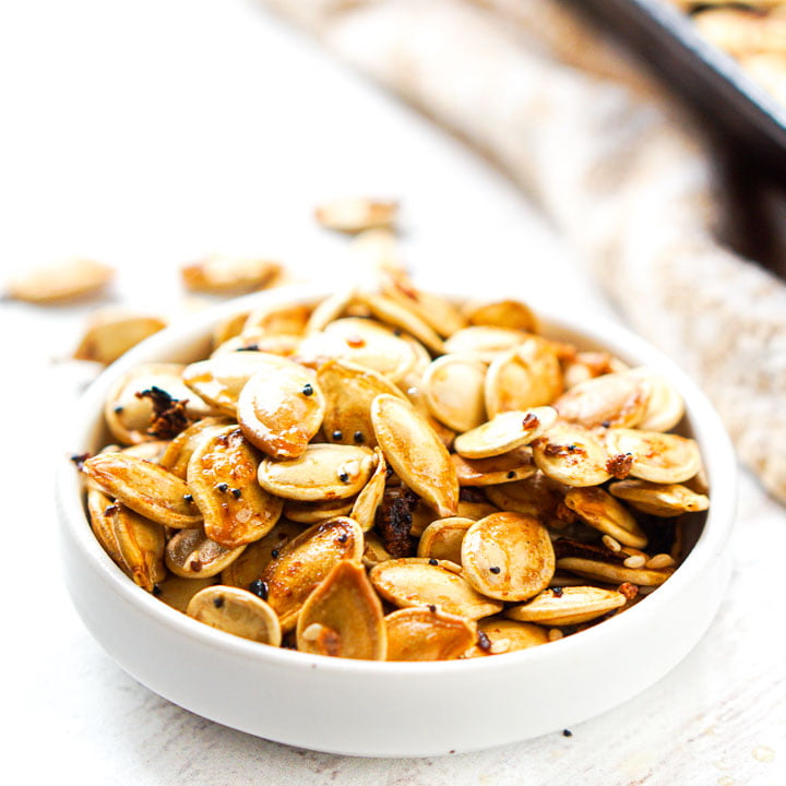 white bowl with low carb pumpkin seeds with everything spice