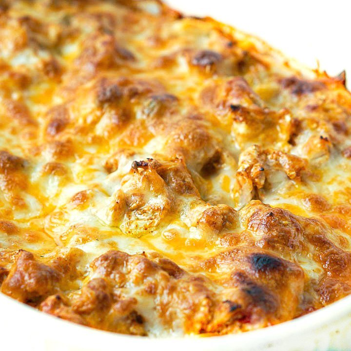 closeup of a baking dish full of keto Mexican chicken casserole with lots of browned cheese on top