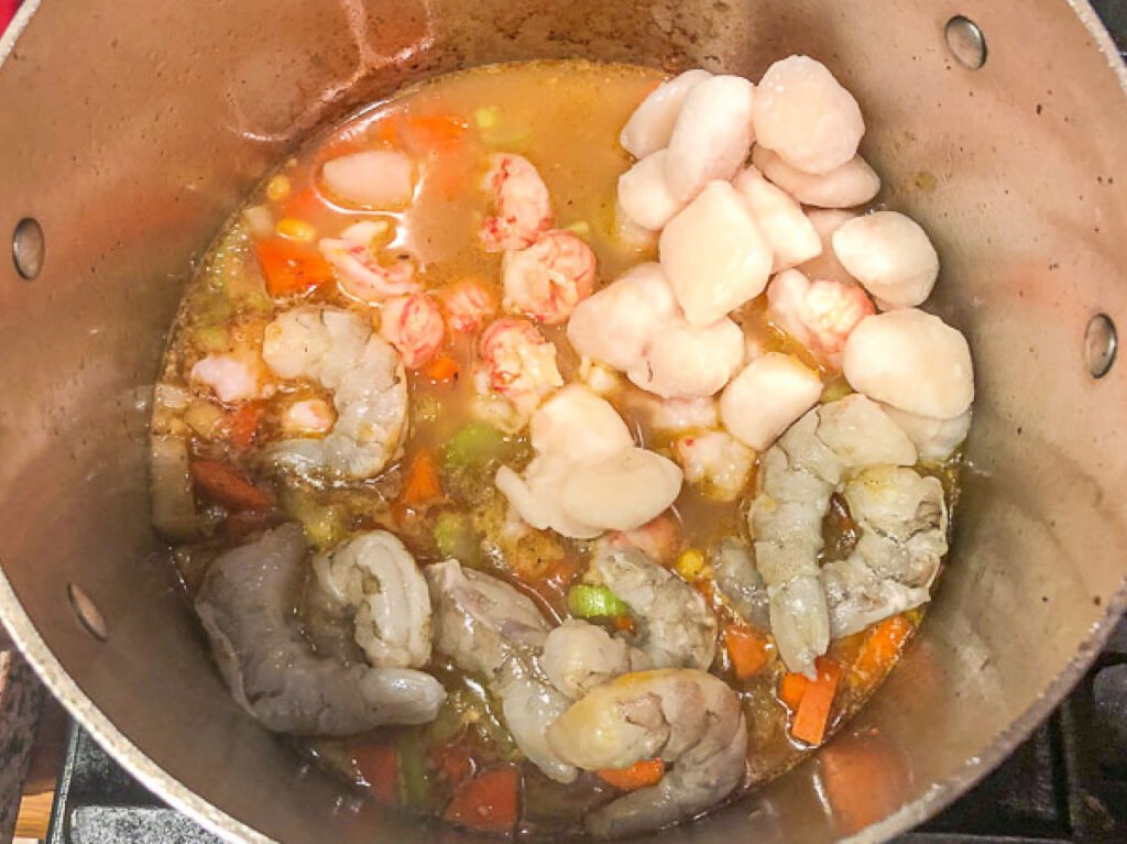 Soup pot with the seafood added.