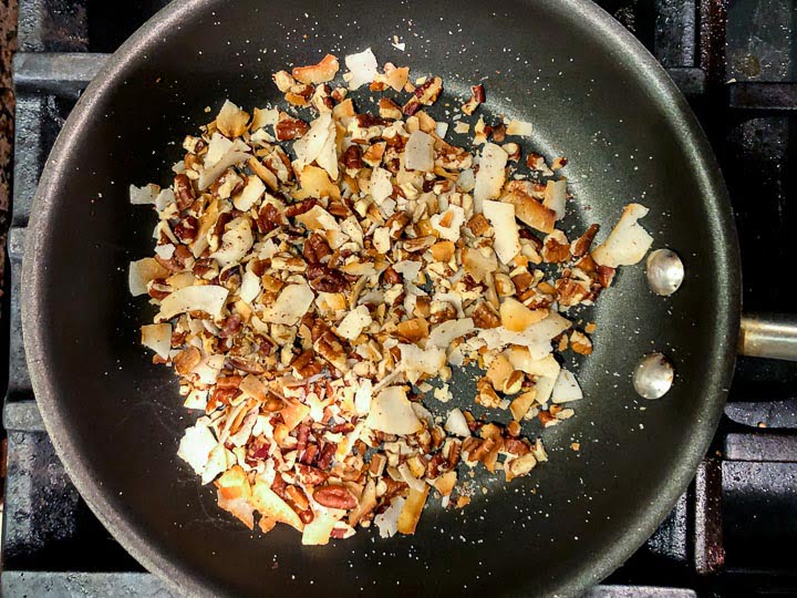 pan with toasted pecans and coconut flakes
