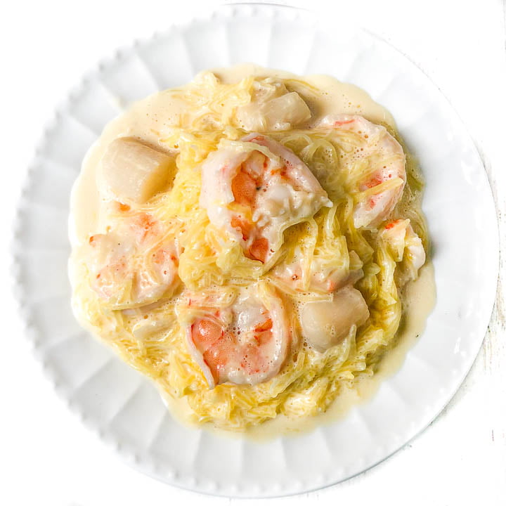 aerial view of a white plate with keto spaghetti squash alfredo with seafood