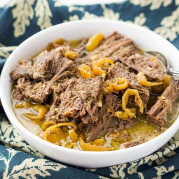 white bowl with Italian roast and banana pepper rings on green tea towel