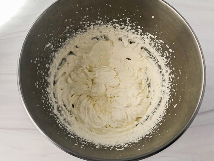 a silver mixing bowl with butterscotch whipped cream